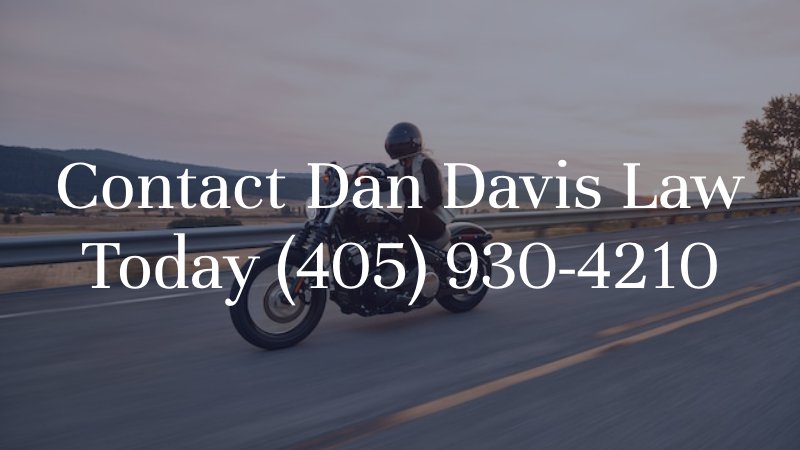 person riding motorcycle on highways with caption: contact dan davis law today (405) 930-4210